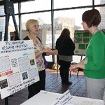 Student explains poster to Women's Center staff member